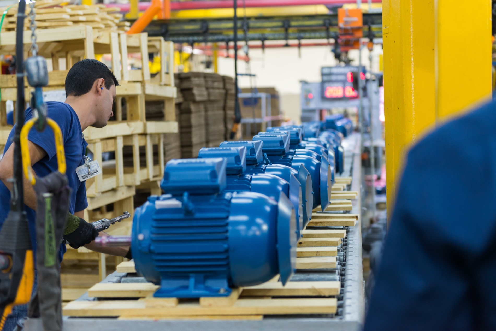 Technician working on electric motors as part of a bearing protection and shaft grounding setup.
