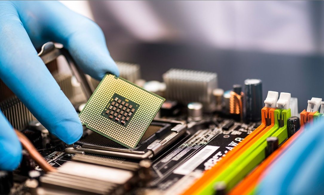 Industrial automation working inserting a smart microchip into an electric motor.