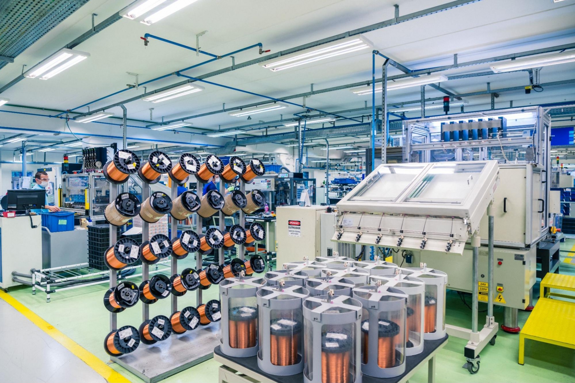 Copper wires being inserted into the Variable Frequency Drive (VFD) unit during the manufacturing process