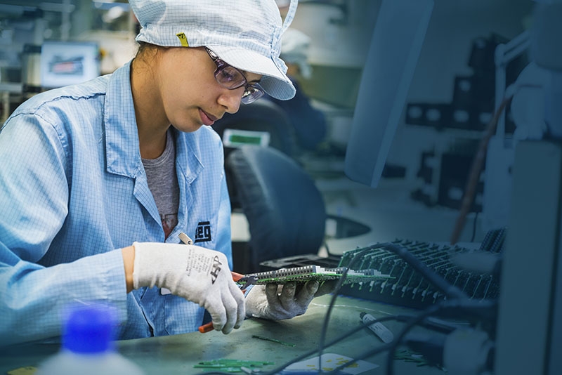 Engineer assembling an electric motor in a clean manufacturing environment, wearing protective gear for industrial automation in food processing.