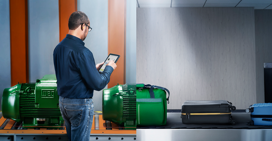 Technician inspecting an industrial electric motor, enhancing operational efficiency in a distribution facility.