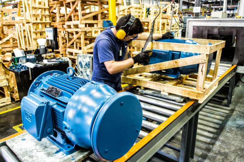 Employee inspecting an electric motor.