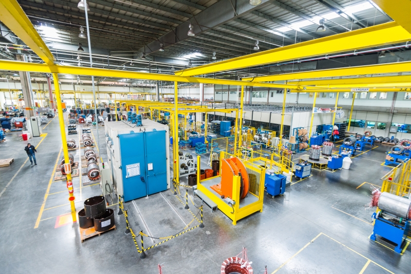 Wide-angle view of a modern manufacturing facility with machinery and equipment, highlighting efficiency and industrial-scale production capabilities.