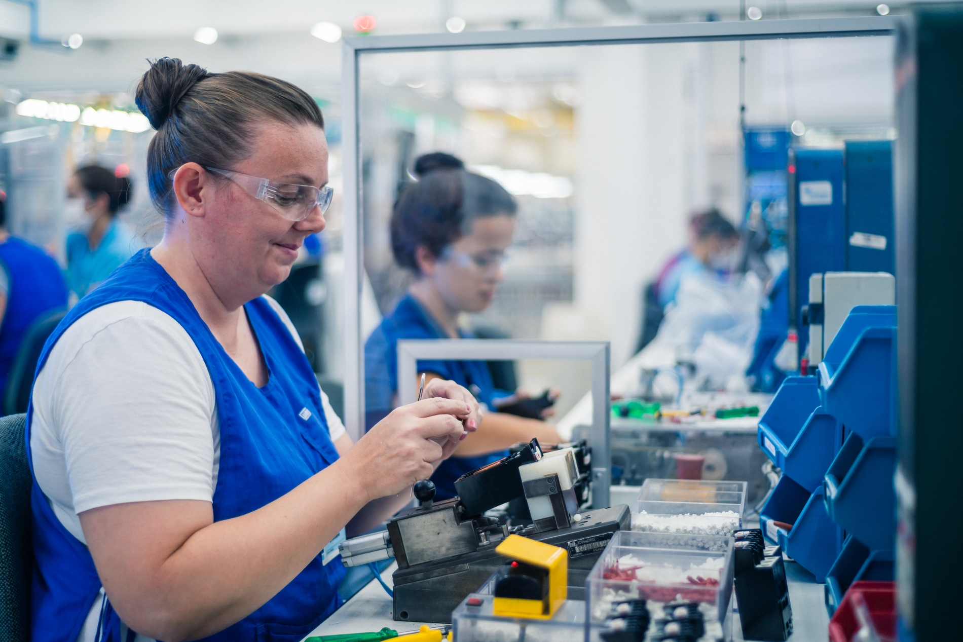 Technician building motor protection devices designed for electric motors, including thermostats, thermistors and RTDs to improve safety and performance.