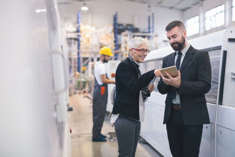 Electric motor distributor going over product description with a factory owner. 